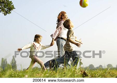Family playing with ball in park View Large Photo Image Picture - Family playing with ball in park . Fotosearch
