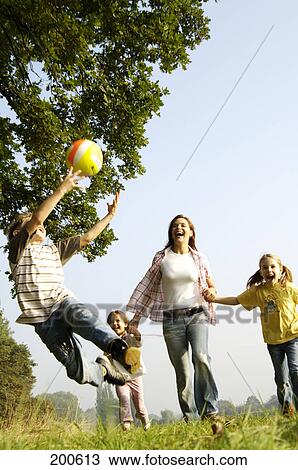 Family playing with ball in park View Large Photo Image Stock Image - Family playing with ball in park . Fotosearch