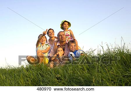 Family sitting in field View Large Photo Image Stock Image - Family sitting in field . Fotosearch