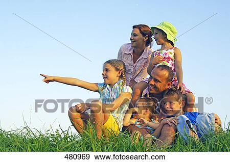 Family smiling in field View Large Photo Image Stock Photo - Family smiling in field . Fotosearch