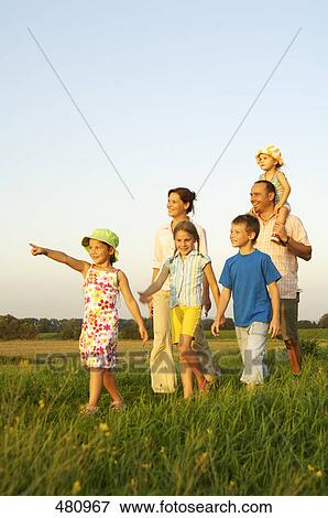 Stock Photo - Family walking in field . Fotosearch