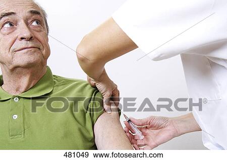 Stock Photo - Femalae doctor taking blood sample from senior man . Fotosearch