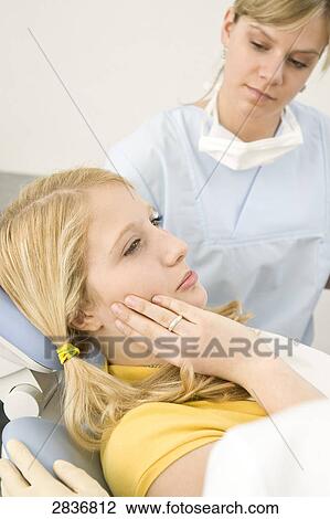 Female dentist and assistant examining patient View Large Photo Image Stock Image - Female dentist and assistant examining patient . Fotosearch
