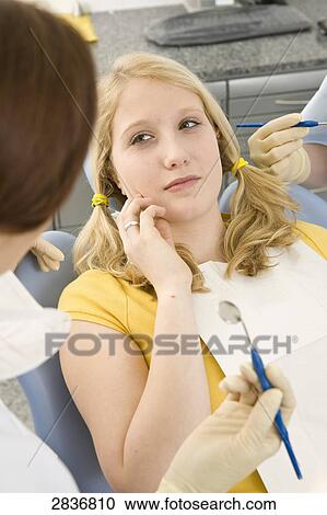 Female dentist examining patient View Large Photo Image Stock Image - Female dentist examining patient . Fotosearch