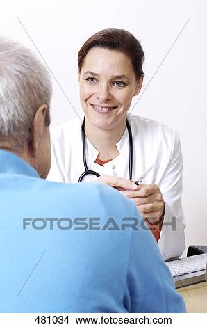 Female doctor talking to patient View Large Photo Image Picture - Female doctor talking to patient . Fotosearch