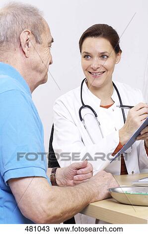 Female doctor talking to patient View Large Photo Image Stock Image - Female doctor talking to patient . Fotosearch