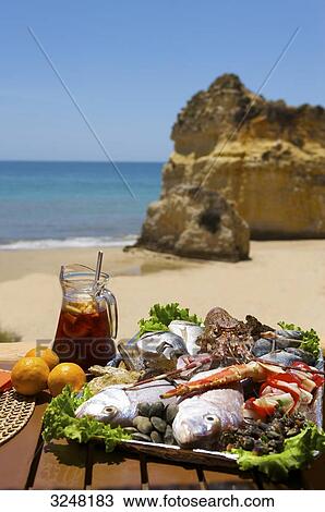 Stock Image - Fish and sangria, Praia dos Tres Irmaos, Alvor, Portugal . Fotosearch