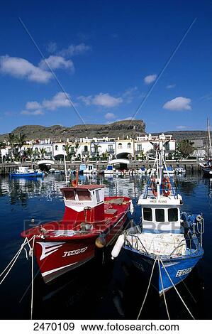 Stock Photo - Fishing boats at harbor, Puerto de Mogan, Gran Canaria, Canary Islands, Spain . Fotosearch