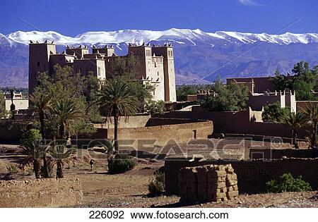 Stock Image - Fort on landscape against mountain range, Dades Valley, Morocco . Fotosearch