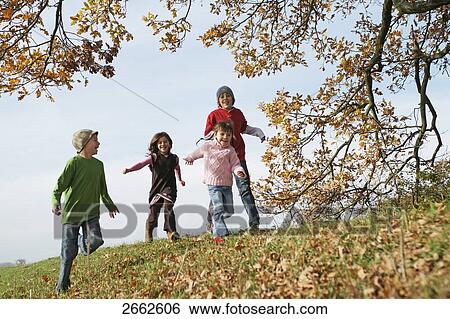 Four children running in park View Large Photo Image Stock Photograph - Four children running in park . Fotosearch