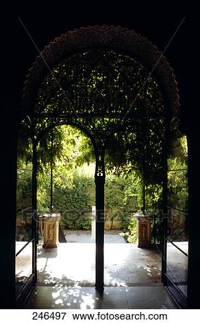 Stock Photo - Garden of palace viewed through arch, Alcazar Palace, Seville, Andalusia, Spain . Fotosearch