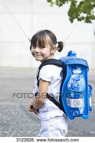 Girl carrying school bag, side view View Large Photo Image Stock Photograph - Girl carrying school bag, side view . Fotosearch