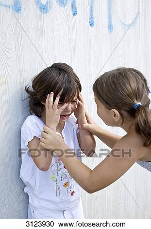 Girl comforting her crying sister View Large Photo Image Stock Image - Girl comforting her crying sister . Fotosearch