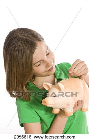 girl doing some money in her piggy bank View Large Photo Image Stock Photograph - girl doing some money in her piggy bank . Fotosearch