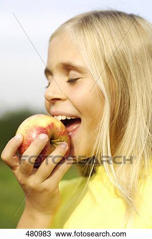 Girl eating apple View Large Photo Image Stock Image - Girl eating apple . Fotosearch