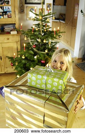 Girl holding christmas presents, elevated view View Large Photo Image Stock Image - Girl holding christmas presents, elevated view . Fotosearch