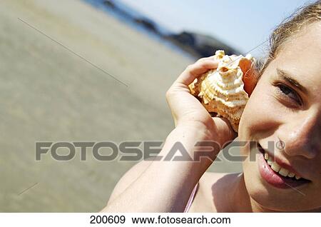 Girl listening to mussle View Large Photo Image Stock Photo - Girl listening to mussle . Fotosearch