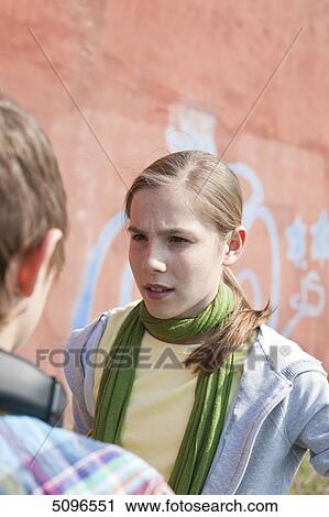 Girl looking at boy with headphones View Large Photo Image Stock Image - Girl looking at boy with headphones . Fotosearch