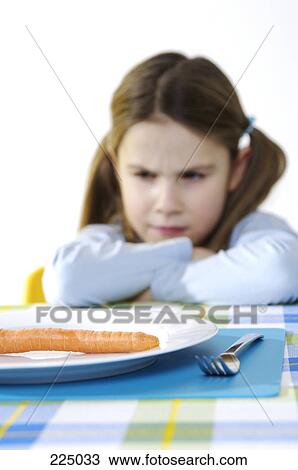 Stock Image - Girl sitting at table . Fotosearch