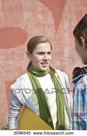 Girl talking to boy with headphones View Large Photo Image Stock Photography - Girl talking to boy with headphones . Fotosearch