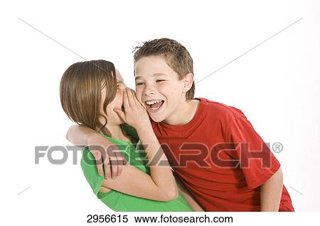 girl whispering something in a boy's ear View Large Photo Image Stock Photography - girl whispering something in a boy's ear . Fotosearch