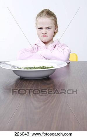Girl with crossed arms sitting at table View Large Photo Image Stock Image - Girl with crossed arms sitting at table . Fotosearch
