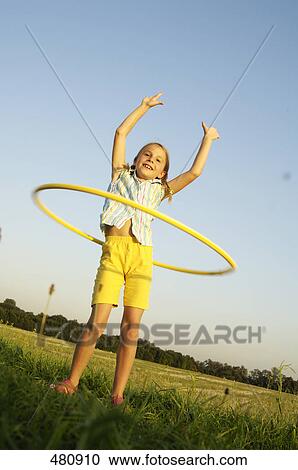 Girl with hula-hoop View Large Photo Image Stock Image - Girl with hula-hoop . Fotosearch