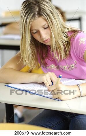 Stock Photo - Girl writing with left hand . Fotosearch