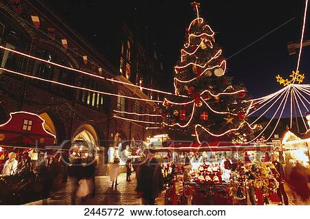 Group of people at lit up Christmas market  View Large Photo Image Stock Image - Group of people at lit up Christmas market . Fotosearch