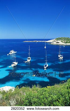 High angle view of boats in sea near coast, Portinatx, Ibiza, Balearic Islands, Spain View Large Photo Image Stock Image - High angle view of boats in sea near coast, Portinatx, Ibiza, Balearic Islands, Spain . Fotosearch