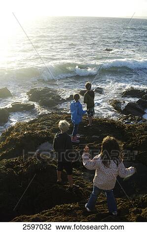 High angle view of four children standing at coast View Large Photo Image Stock Image - High angle view of four children standing at coast . Fotosearch