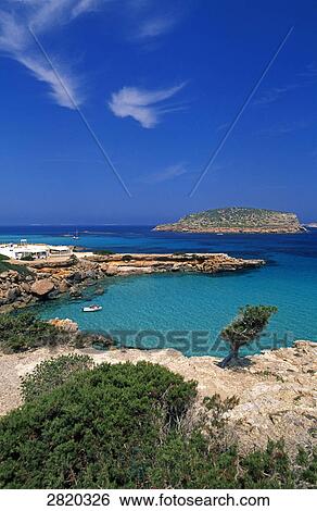 Stock Photograph - High angle view of resort at coast, Cala Comte, Ibiza, Balearic Islands, Spain . Fotosearch