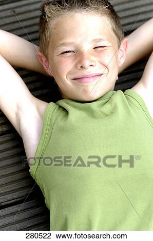 Stock Image - High angle view of teenage boy smiling . Fotosearch