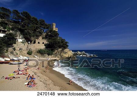 Stock Photo - High angle view of tourists enjoying on beach, Lloret de Mar, Gerona, Catalonia, Spain . Fotosearch
