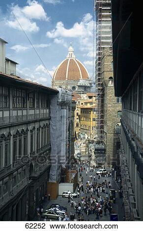 Stock Image - High angle view of tourists walking through street, Tuscany, Italy, Europe . Fotosearch