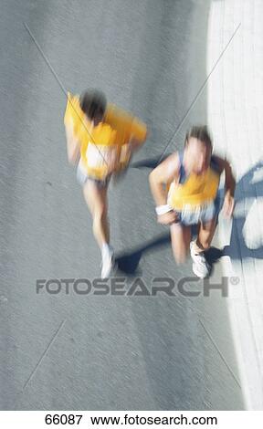 High angle view of two people running in marathon View Large Photo Image Stock Photo - High angle view of two people running in marathon . Fotosearch