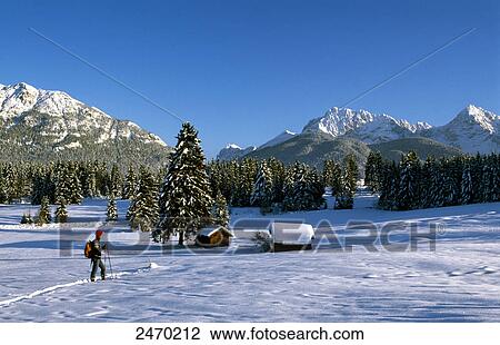Hiker walking on snow-covered landscape View Large Photo Image Stock Image - Hiker walking on snow-covered landscape . Fotosearch