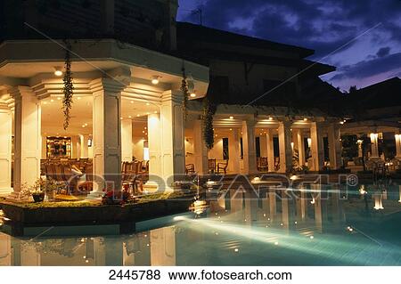 Stock Photo - Hotel lit up at poolside, Sri Lanka . Fotosearch
