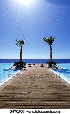 Stock Photograph - Jetty in infinity pool, Funchal, Madeira, Portugal . Fotosearch