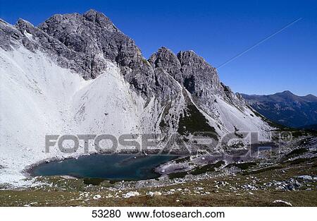 Lake in front of mountains, Alpine Lake, Alps, Austria View Large Photo Image Stock Image - Lake in front of mountains, Alpine Lake, Alps, Austria . Fotosearch