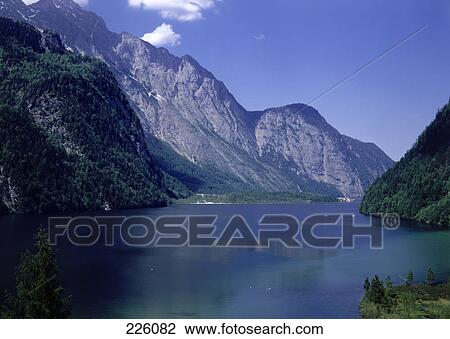 Lake surrounded by mountains, Mount Watzmann, Hachelkoepfe, Koenigssee, Berchtesgaden, Bavaria, Germany View Large Photo Image Stock Image - Lake surrounded by mountains, Mount Watzmann, Hachelkoepfe, Koenigssee, Berchtesgaden, Bavaria, Germany . Fotosearch