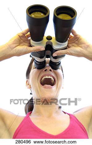 Laughing woman looking through binocular View Large Photo Image Stock Photograph - Laughing woman looking through binocular . Fotosearch