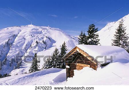 Stock Image - Log cabin on snow covered landscape, Sankt Anton am Arlberg, Tyrol, Austria . Fotosearch