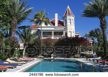 Stock Photograph - Lounge chairs at poolside, Florida, USA . Fotosearch