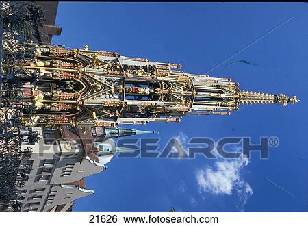 Stock Photograph - Low angle view of gothic style fountain, Schoener Brunnen, Nuremberg, Bavaria, Germany . Fotosearch