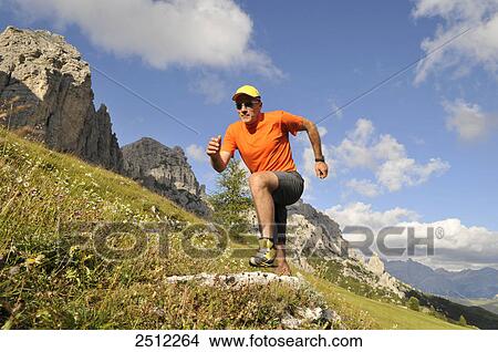 Low angle view of mature man running on landscape, Trentino-Alto Adige, Italy View Large Photo Image Picture - Low angle view of mature man running on landscape, Trentino-Alto Adige, Italy . Fotosearch