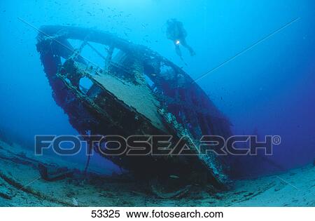 Low angle view of scuba diver swimming above shipwreck underwater View Large Photo Image Stock Photography - Low angle view of scuba diver swimming above shipwreck underwater . Fotosearch