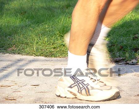 Low section view of person jogging in park View Large Photo Image Stock Photograph - Low section view of person jogging in park . Fotosearch