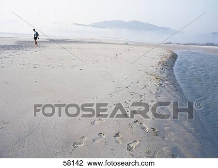 Male tourist standing on the beach View Large Photo Image Stock Image - Male tourist standing on the beach . Fotosearch