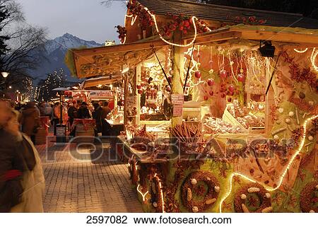 Stock Image - Market stalls lit up at dusk during Christmas . Fotosearch